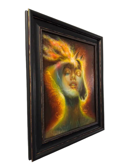 Framed artwork of a colorful face with a dark frame on a white wall