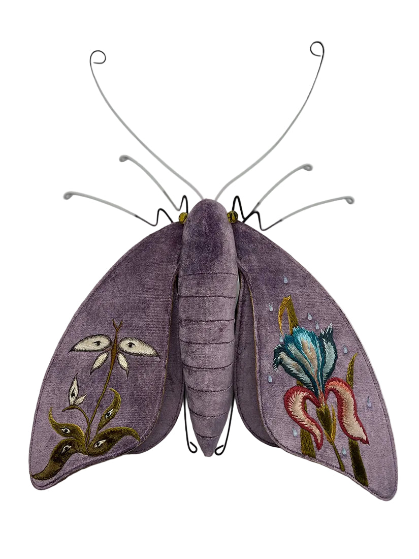 Decorative butterfly with embroidered wings on a white background