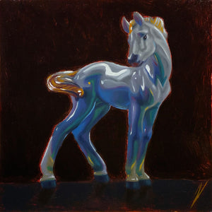 Colorful horse figurine on a dark background