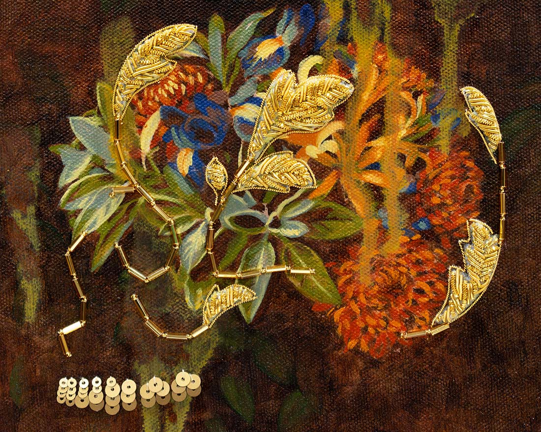 Gold leaf-shaped brooches on a textured fabric background