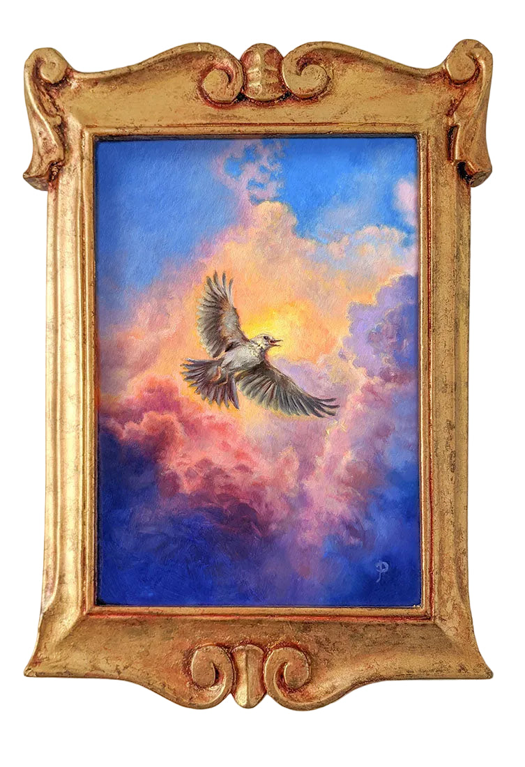 A framed painting depicting a flying bird in a dramatic sky with blue, pink, and orange clouds, set in an ornate gold frame against a light gray wall.