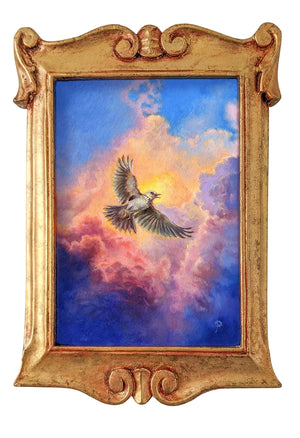 A framed painting depicting a flying bird in a dramatic sky with blue, pink, and orange clouds, set in an ornate gold frame against a light gray wall.