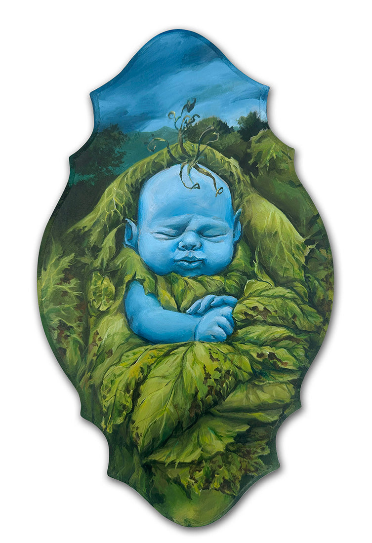 Blue baby surrounded by green leaves with a blue sky background