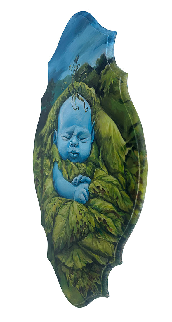 Decorative plaque with a blue baby figure wrapped in green fabric on a white background