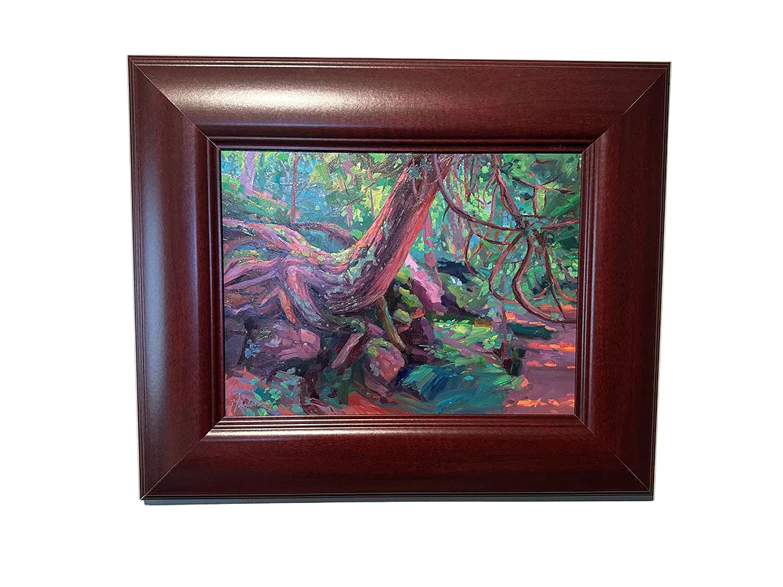 Framed painting of a forest scene with colorful trees on a beige wall.