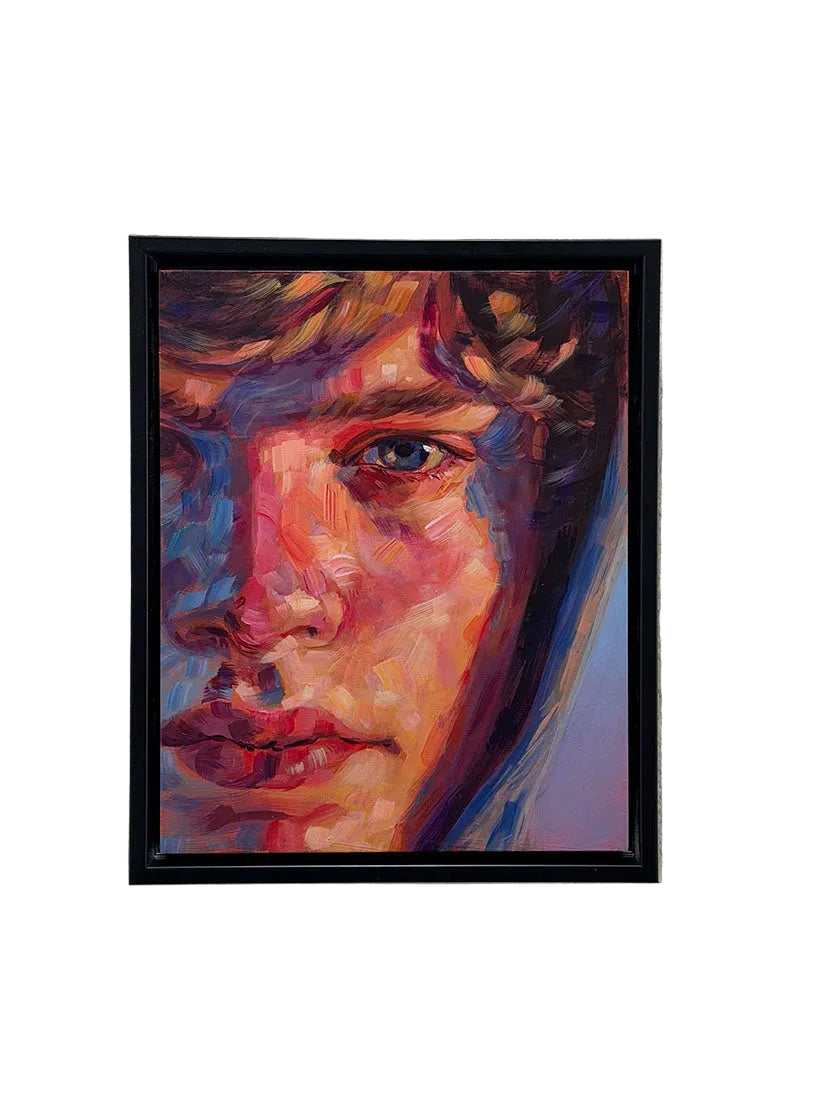 A framed portrait painting of a man's face, rendered in expressive multicolored brushstrokes with prominent red, blue, purple, and orange tones, hanging on a textured white wall.