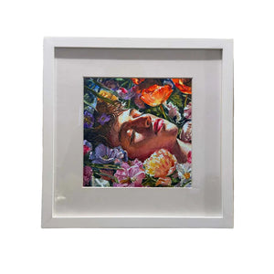 Framed artwork of a person surrounded by flowers on a textured wall.