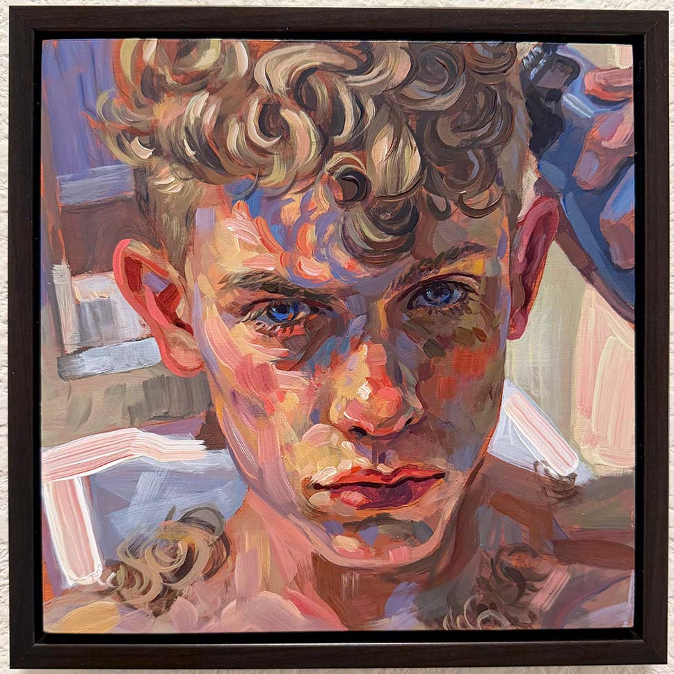 A framed portrait painting of a young man with curly blond hair, rendered in expressive brushstrokes with blue, pink, orange, and beige tones, hanging on a textured white wall.