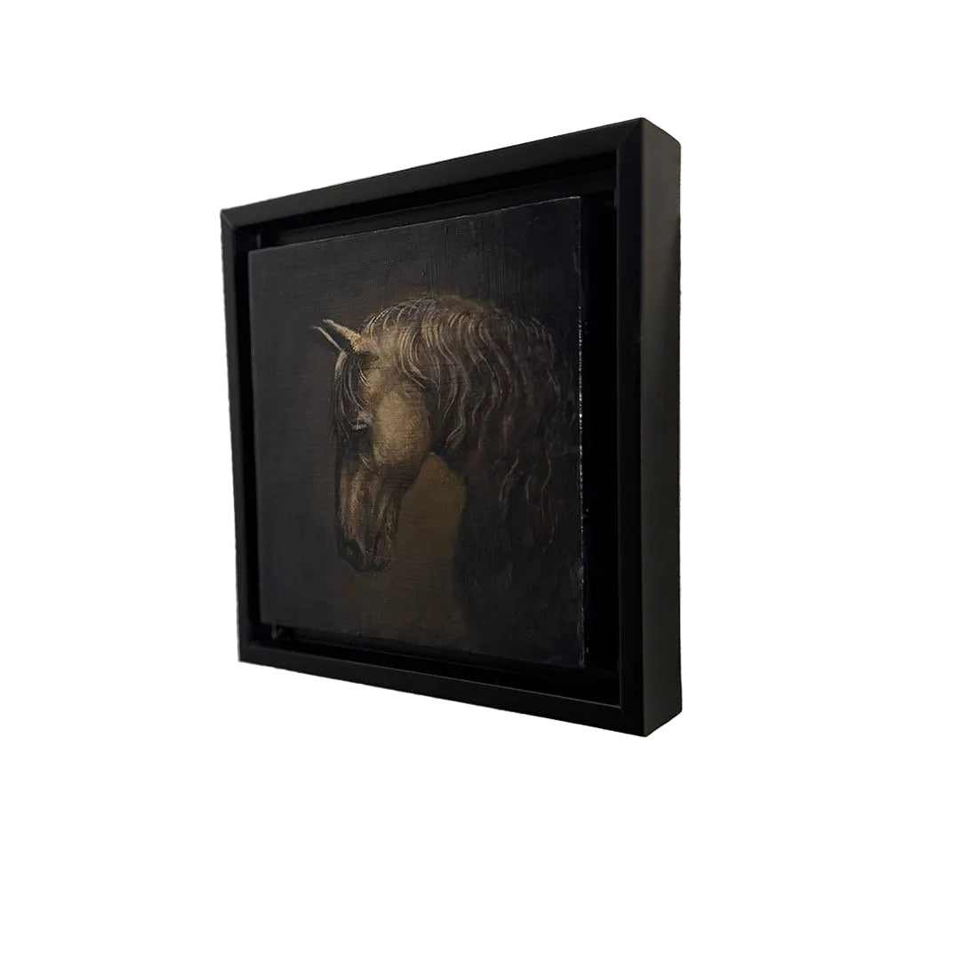 Framed artwork of a horse's head on a textured wall
