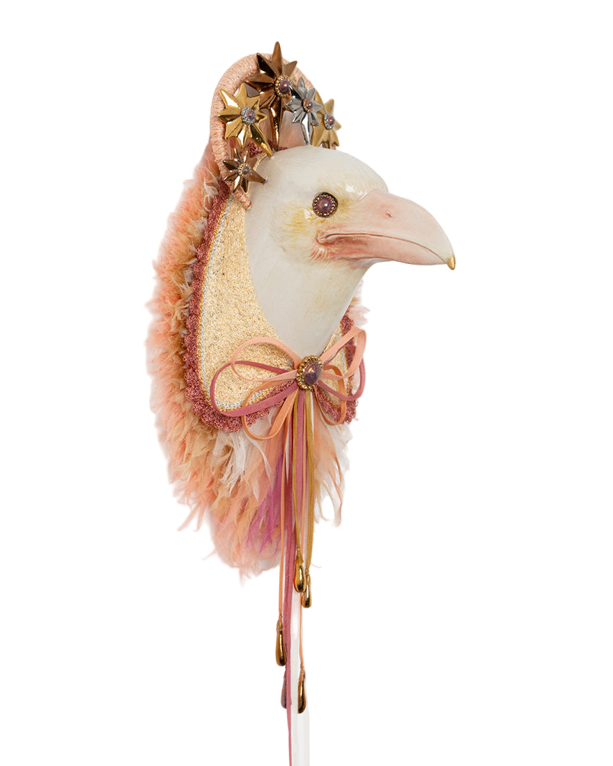 Decorative bird head with feathers and gold accents on a white background