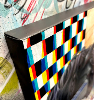 Colorful canvas against a textured wall with abstract art