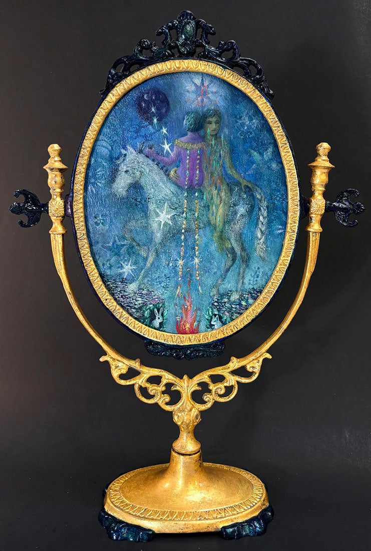 Decorative piece with a figure on a horse inside an ornate frame against a dark background