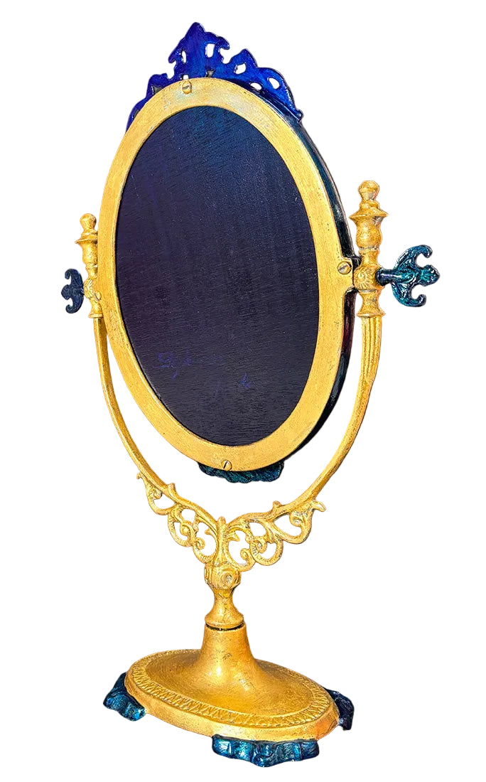 Decorative object with a figure on a horse inside an ornate frame against a dark background