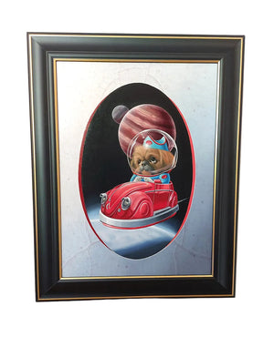 A framed painting featuring a small dog dressed as an astronaut driving a red car in space, mounted on a light-colored wall.
