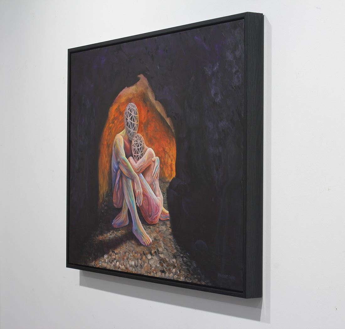 A framed square canvas painting hanging on a white wall, depicting a seated figure in a dark cave-like scene with a glowing orange and pink opening behind them.
