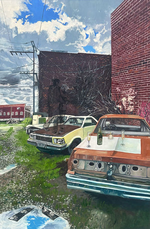 Two vintage cars modified as outdoor dining tables with drinks on a grassy area near a brick building.