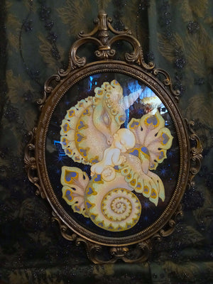 Decorative piece with a gold frame featuring a central design on a dark background